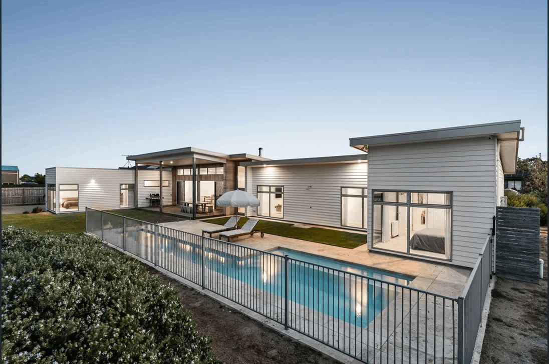 Aluminium pool fencing around a home at dusk
