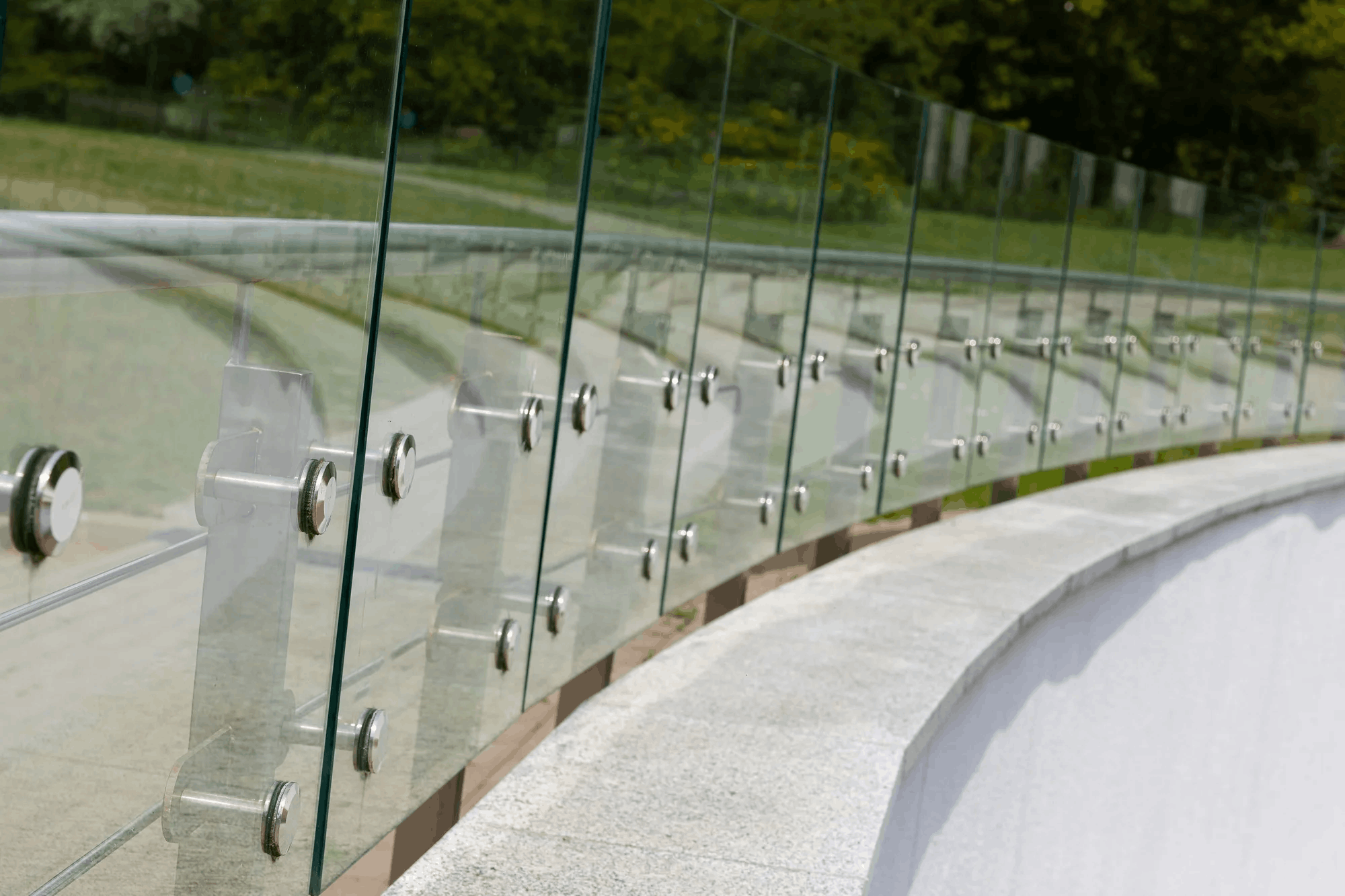 Close-up of glass balustrade fixings on a curved commercial balcony