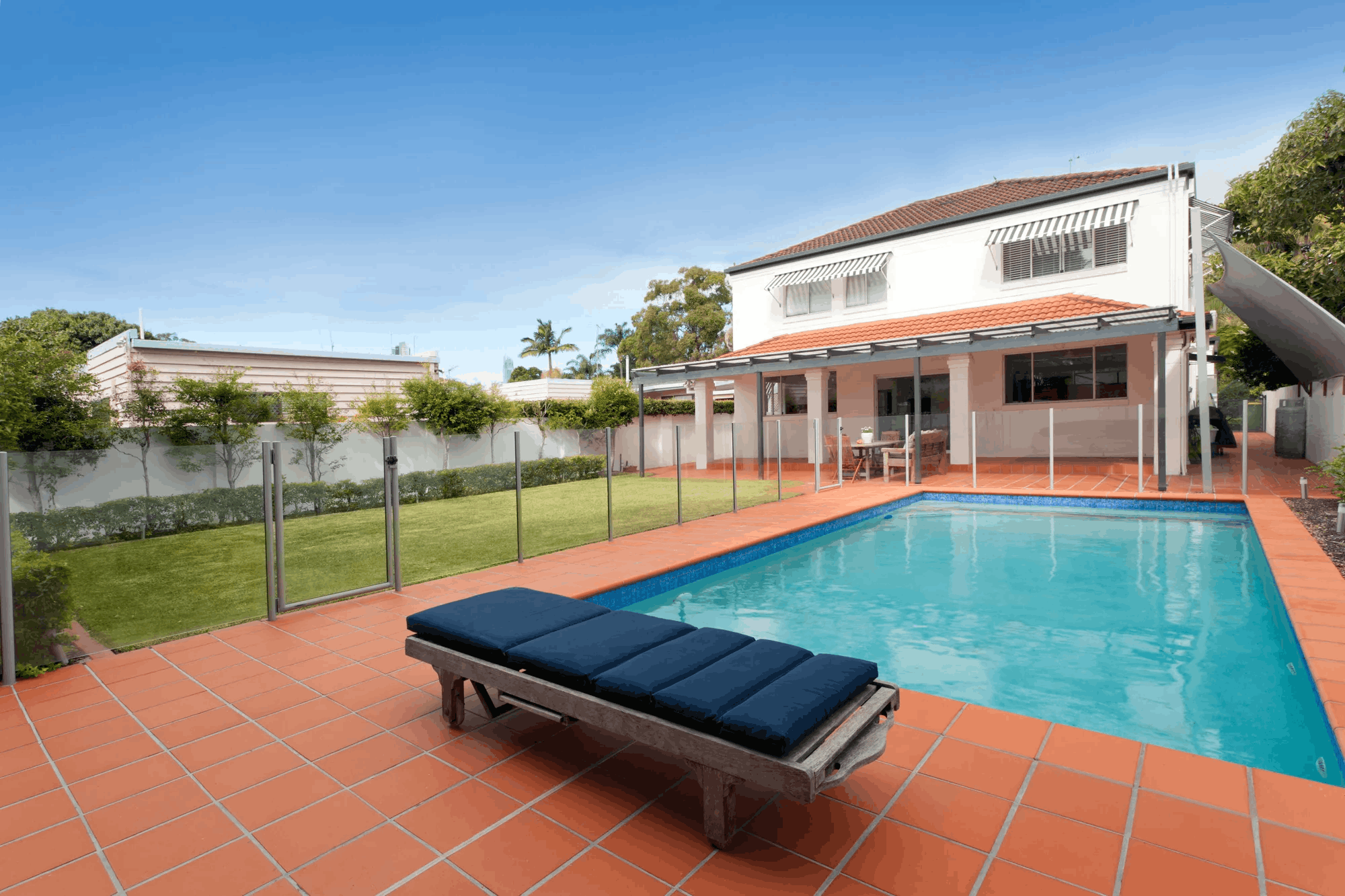 Semi-frameless glass pool fence around a Brisbane southside pool