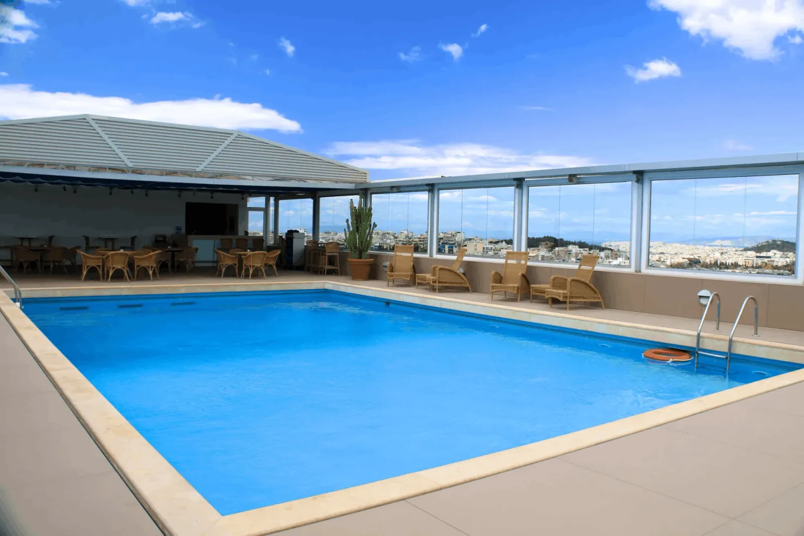 Rooftop pool with a glass balustrade rail, a body-corporate style setting