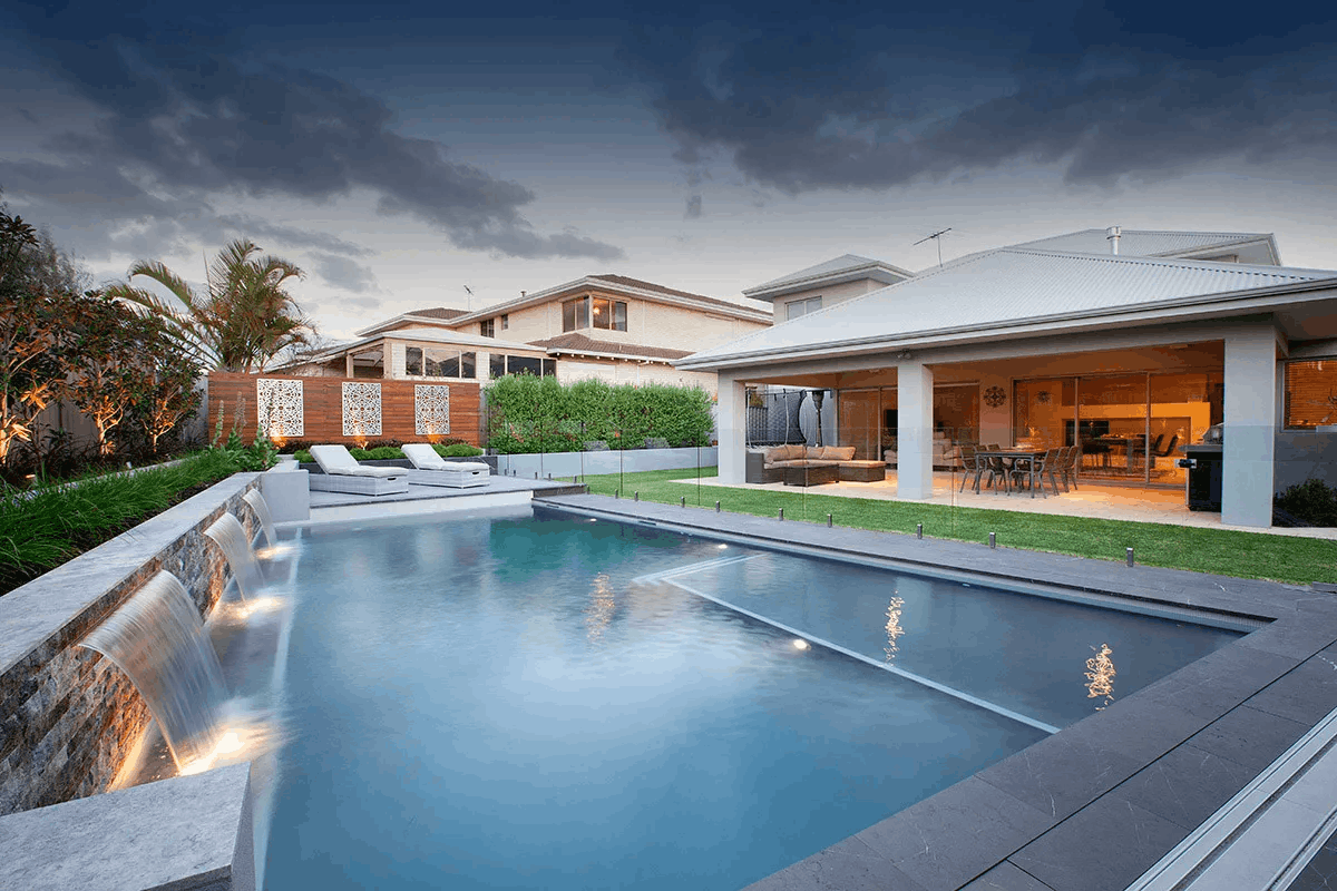 Pool fencing installed beside an outdoor entertaining area at dusk